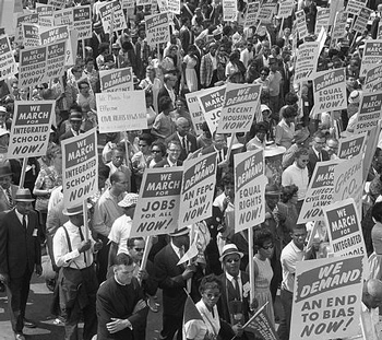 Historic black and white photo of signs carried by many marchers during the March on Washington, 1963