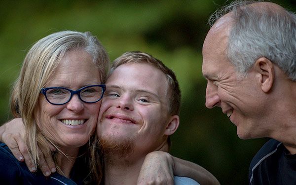 GLOBAL Inclusive Program student poses for photo with his parents