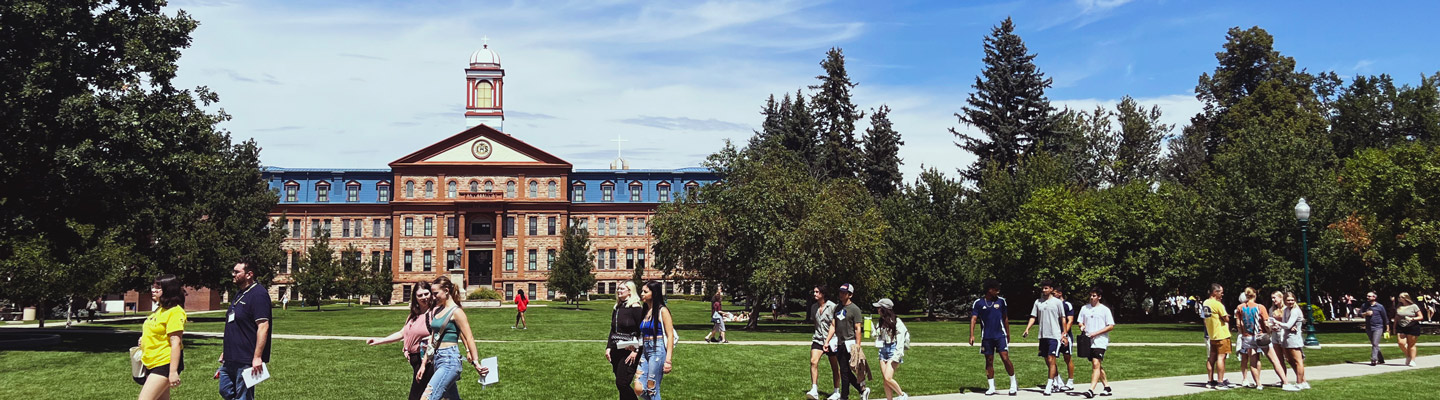 large number of students walking in small groups in the quad on Northwest Denver campus on a bright, sunny summer day 