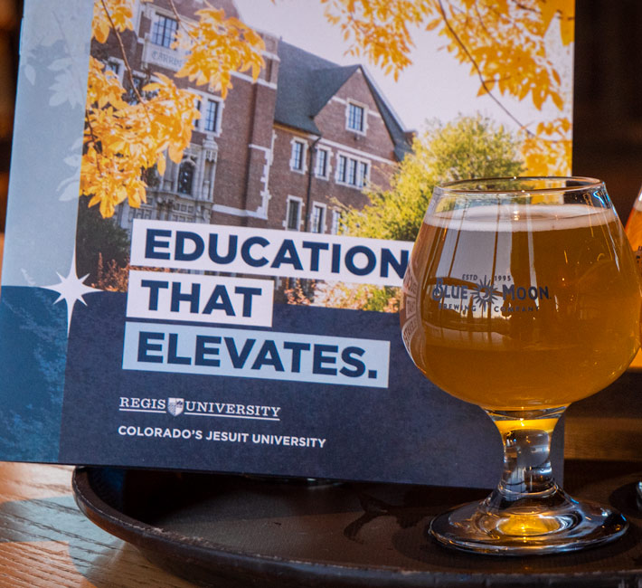 Education that elevates booklet on the left side. Blue Moon glass on the right