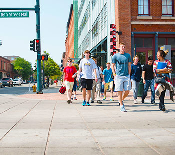 a group of Regis students crosses the street in a crosswalk on 16th Street Mall in downtown denver