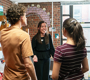 an Admissions staff person shows off a dorm room to prospective students during an event on the Northwest Denver Campus