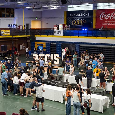 a view of a crowd of Iggy Beerfest attendees enjoying tastings and festivities in the fieldhouse