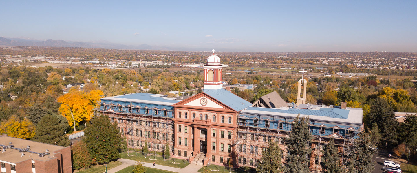 aerial view of Main Hall on Northwest Denver campus, with view of Rocky Mountains in background