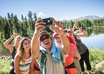 Students taking selfie at lake