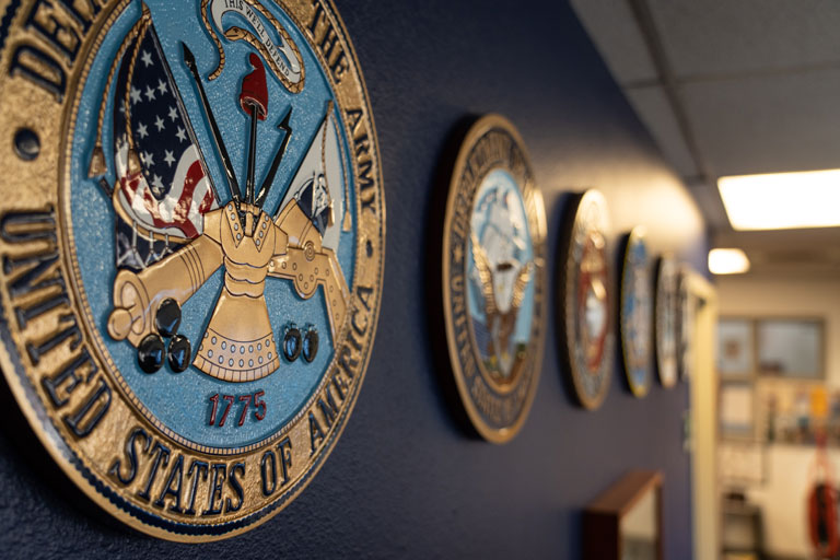 Every military branch seal on the wall