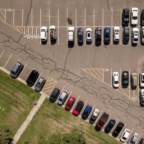 aerial view of cars parked in parking lot on the Regis campus