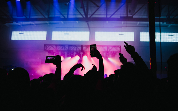 People holding phones at a music venue