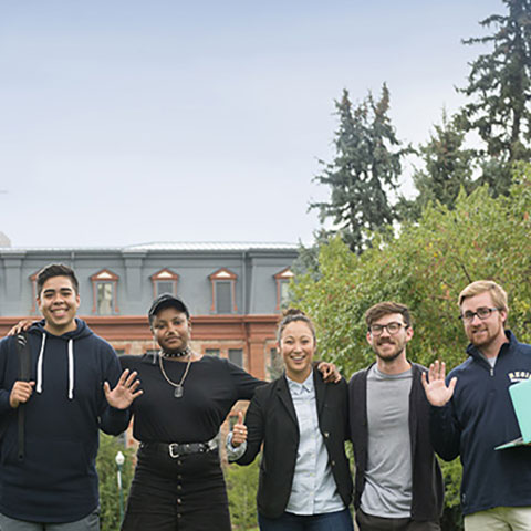 RUSGA students pose for a photo in front of main hall on the regis campus