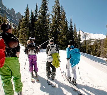 Regis students wearing ski gear enjoy the snow covered rocky mountains