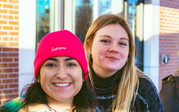 three friends pose for a photo outdoors during SnowJam on the Northwest Denver Campus