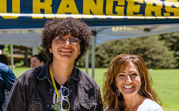 Student and faculty member post together for a photo