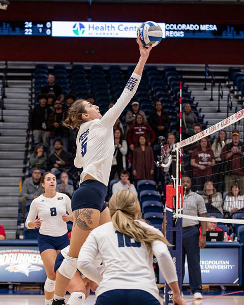 Klaudia jumping up to hit a volleyball