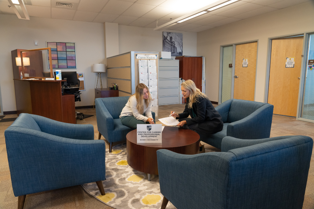 women go over documents in career center