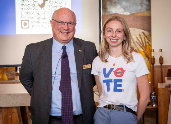 deputy Secretary of State and student smile for photo