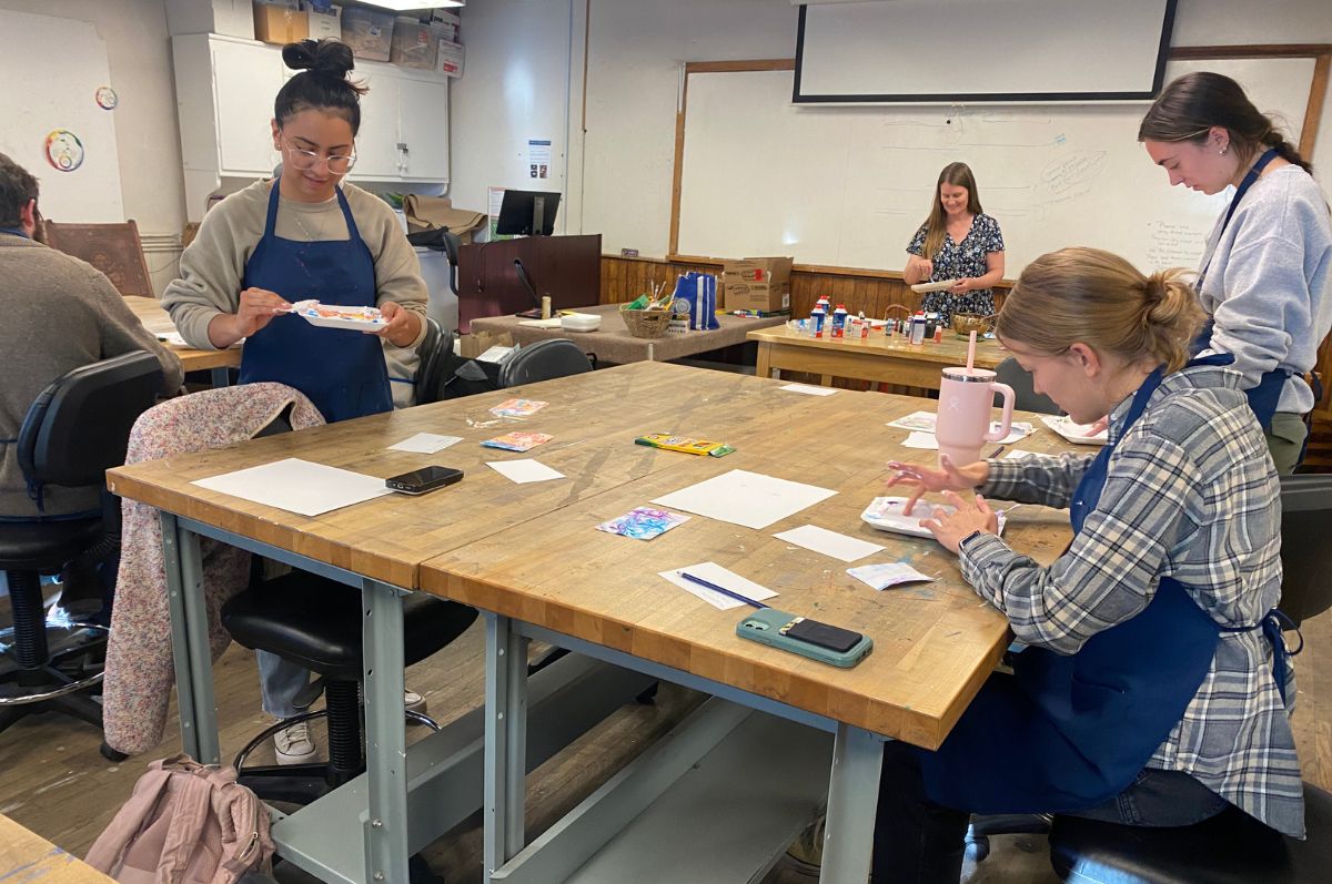 Shot of regis students working around a table