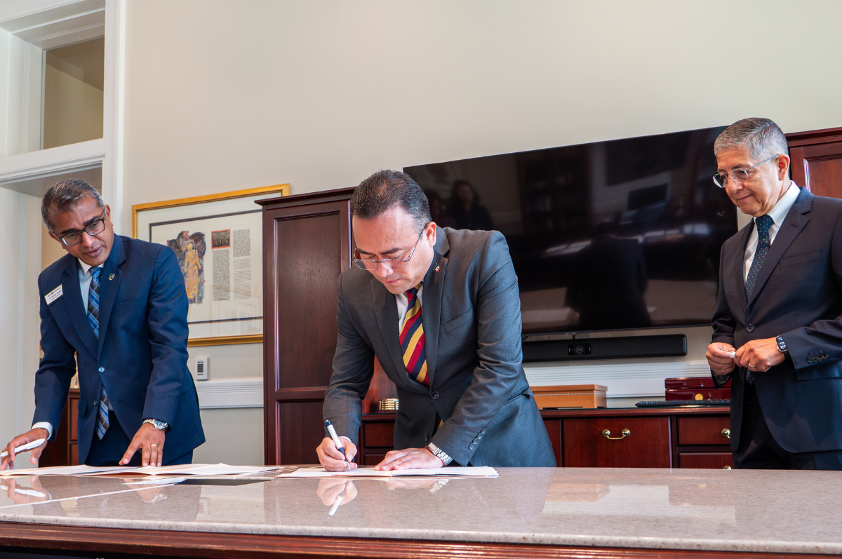 Consul General of Mexico in Denver Pavel Melendez Cruz signs a document