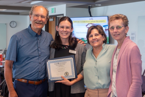 award recipient smiles with donors and dean